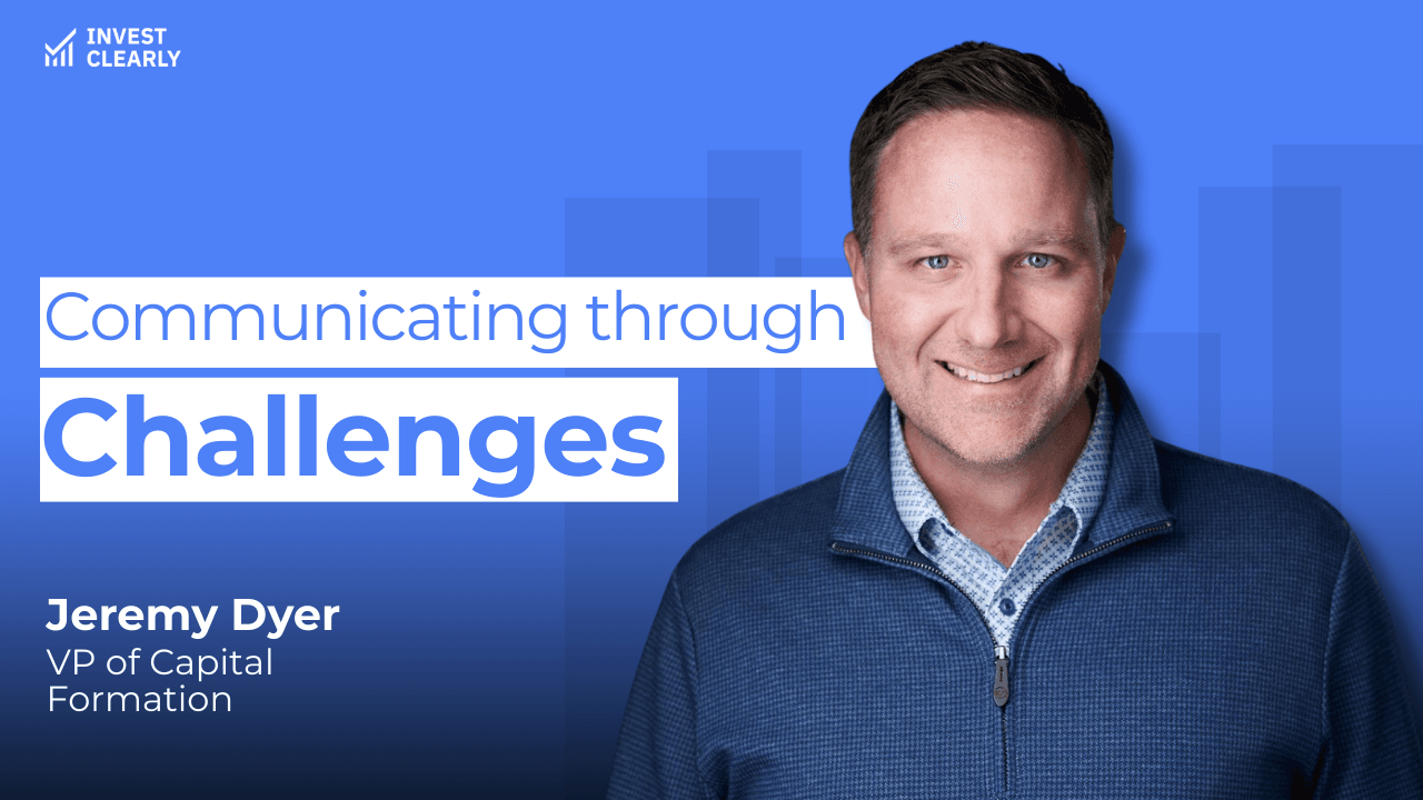 A promotional graphic for Invest Clearly featuring Jeremy Dyer, VP of Capital Formation. The text reads “Communicating through Challenges.” Jeremy is smiling and wearing a blue zip-up sweater over a light patterned shirt against a blue gradient background with subtle geometric shapes and the Invest Clearly logo in the top left corner.
